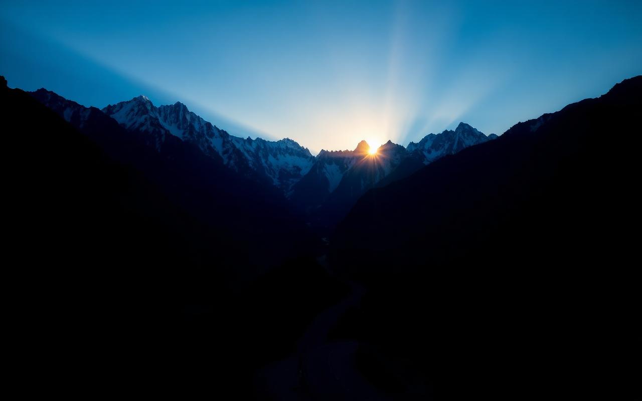 Dawn light on the Karakoram range above a mountain road